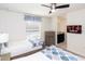 Comfortable bedroom with ceiling fan, TV, two twin beds, and an adjacent bathroom at 8924 Bengal Ct, Kissimmee, FL 34747
