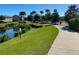 Pristine community walking path near the pond, featuring manicured landscaping and lush green grass at 8924 Bengal Ct, Kissimmee, FL 34747