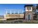 Windsor at Westside community entrance with stone tower, pergola, and manicured landscaping at 8924 Bengal Ct, Kissimmee, FL 34747