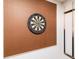 Game room with a dartboard and pool cues displayed on the wall, ready for entertainment at 8924 Bengal Ct, Kissimmee, FL 34747