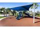 Community playground featuring slides, climbing structures, and shade at 8924 Bengal Ct, Kissimmee, FL 34747