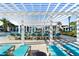 Poolside lounge chairs beneath a trellis with community buildings in the background at 8924 Bengal Ct, Kissimmee, FL 34747