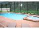 Gorgeous backyard pool and jacuzzi area with a privacy screen and space for lounge chairs at 8924 Bengal Ct, Kissimmee, FL 34747
