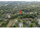 An aerial view shows this home nestled in a private, heavily wooded community, offering seclusion and natural beauty at 903 Oak Leaf Ct, Altamonte Springs, FL 32714