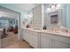 Elegant bathroom with dual sinks, vanity with a marble countertop and mirrors, and plenty of storage at 903 Oak Leaf Ct, Altamonte Springs, FL 32714
