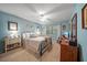 Comfortable bedroom with soft blue walls, neutral carpet, and a ceiling fan, with plenty of natural light at 903 Oak Leaf Ct, Altamonte Springs, FL 32714