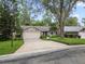 A single-story home featuring a two-car garage, well-manicured lawn, and beautiful landscaping at 903 Oak Leaf Ct, Altamonte Springs, FL 32714