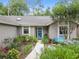 Inviting home exterior with a beautifully landscaped walkway leading to a vibrant, blue front door at 903 Oak Leaf Ct, Altamonte Springs, FL 32714