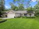 Charming single-story home with a well-manicured lawn, lush landscaping, and an attached two-car garage at 903 Oak Leaf Ct, Altamonte Springs, FL 32714
