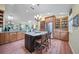 Bright kitchen features wood cabinets, granite countertops, stainless steel appliances, and a center island with seating at 903 Oak Leaf Ct, Altamonte Springs, FL 32714