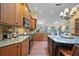 Kitchen area featuring stainless steel appliances, granite countertops and breakfast bar, seamlessly flowing into the living area at 903 Oak Leaf Ct, Altamonte Springs, FL 32714