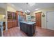 Bright kitchen featuring a large center island with granite countertops, stainless steel refrigerator and wooden cabinets at 903 Oak Leaf Ct, Altamonte Springs, FL 32714