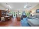 Spacious living room and dining area with wood floors, skylights, and comfortable seating at 903 Oak Leaf Ct, Altamonte Springs, FL 32714