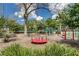 A well-maintained community playground with swings, slides, and a merry-go-round, perfect for outdoor activities at 903 Oak Leaf Ct, Altamonte Springs, FL 32714