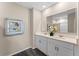 Bathroom featuring a double vanity, framed mirrors, a walk-in shower, and wood-look flooring at 984 Commons Way, Port Orange, FL 32129