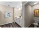 Well-lit powder room featuring a modern vanity, framed mirror, and wood-look flooring at 984 Commons Way, Port Orange, FL 32129