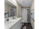 Bright bathroom with a double vanity, quartz countertops, and a tiled shower-tub combination at 984 Commons Way, Port Orange, FL 32129