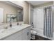 Bathroom featuring a double vanity with quartz countertops, a large mirror, and a bathtub with a shower at 984 Commons Way, Port Orange, FL 32129
