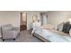 Bedroom featuring a sitting area, ensuite bathroom, neutral decor, and large windows at 984 Commons Way, Port Orange, FL 32129