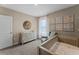 Charming Bedroom with a crib, dresser, and an accent wall with soft pink and neutral tones at 984 Commons Way, Port Orange, FL 32129
