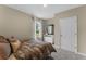 Comfortable bedroom featuring a patterned bedspread, a window, and soft, neutral-colored walls at 984 Commons Way, Port Orange, FL 32129