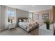 Bright bedroom featuring large windows, a neutral color scheme, and stylish decor at 984 Commons Way, Port Orange, FL 32129