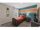 Stylish bedroom featuring a unique bed frame, colorful accent wall, and natural light from the window at 984 Commons Way, Port Orange, FL 32129