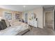 Bedroom with large bed, soft neutral colors, ensuite bathroom, and decorative wall art at 984 Commons Way, Port Orange, FL 32129
