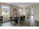 Elegant dining room with wood floors, decorative art, and abundant natural light at 984 Commons Way, Port Orange, FL 32129