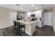 Modern kitchen with white cabinets, stainless steel appliances, and a large island with barstool seating at 984 Commons Way, Port Orange, FL 32129