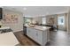 Modern kitchen with a center island, stainless steel appliances, and an open floor plan to the dining and living area at 984 Commons Way, Port Orange, FL 32129