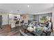 Open-concept living room and kitchen layout featuring hard wood floors and a dining table at 984 Commons Way, Port Orange, FL 32129