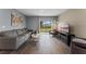 Relaxing living area features hardwood floors, comfortable seating, and sliding glass doors to the backyard at 984 Commons Way, Port Orange, FL 32129