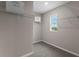 Walk-in closet with carpeted floors, shelving, and a window for natural light at 984 Commons Way, Port Orange, FL 32129
