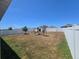 Backyard with vinyl fence, large grass area and play set at 1596 Park Side Ave, Kissimmee, FL 34744