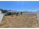 Backyard with vinyl fence, large grass area and play set at 1596 Park Side Ave, Kissimmee, FL 34744