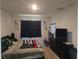 Cozy bedroom featuring black out curtains, bed with a Firefighter flag, and a dresser at 1596 Park Side Ave, Kissimmee, FL 34744