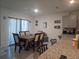 Open dining area featuring a table, chairs, and view into the kitchen space with an island at 1596 Park Side Ave, Kissimmee, FL 34744
