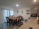 Open dining area featuring a table, chairs, and view into the kitchen space with an island at 1596 Park Side Ave, Kissimmee, FL 34744