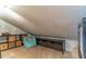 Cozy attic space with a sloped ceiling, featuring neutral carpet and storage solutions at 103 Golf Club Dr, Longwood, FL 32779