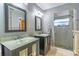 Bathroom with double sink vanity, mirrors, and walk-in shower with glass door at 103 Golf Club Dr, Longwood, FL 32779
