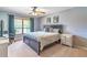 Bedroom with large window, ceiling fan, and neutral decor at 103 Golf Club Dr, Longwood, FL 32779