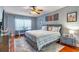 Comfortable bedroom with a ceiling fan, modern decor, and natural light at 103 Golf Club Dr, Longwood, FL 32779