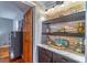 Elegant dry bar featuring stylish shelving, decorative lighting, and beautiful countertops at 103 Golf Club Dr, Longwood, FL 32779