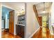 Welcoming foyer featuring hardwood floors, a staircase, and a stylish dry bar for entertaining at 103 Golf Club Dr, Longwood, FL 32779