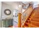 Bright foyer with staircase and arched doorway to kitchen area at 103 Golf Club Dr, Longwood, FL 32779