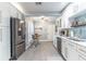 Bright kitchen with white cabinets, modern backsplash, stainless steel appliances, and dining area at 103 Golf Club Dr, Longwood, FL 32779