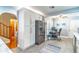 Modern kitchen with white cabinets, stainless steel refrigerator, and adjacent office space at 103 Golf Club Dr, Longwood, FL 32779