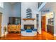Stylish living room with a cozy fireplace, modern furniture, and beautiful hardwood floors at 103 Golf Club Dr, Longwood, FL 32779