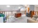 Cozy loft area with comfortable seating, skylights, and wood railing at 103 Golf Club Dr, Longwood, FL 32779